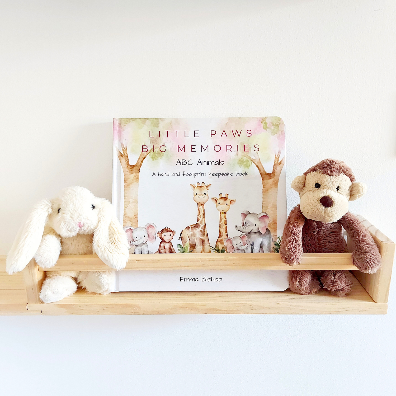 Little Paws Big Memories ABC Animals baby hand and footprint memory book displayed on nursery shelf with soft toys by Tiny Tiptoes