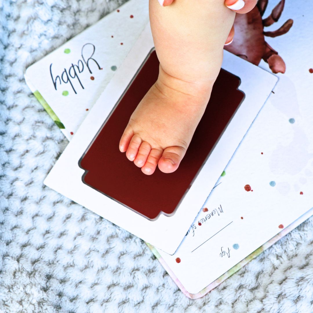 Baby using mess-free clean touch ink pad for hand and footprint keepsake