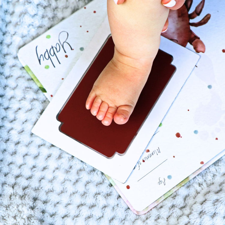 Baby using mess-free clean touch ink pad for hand and footprint keepsake