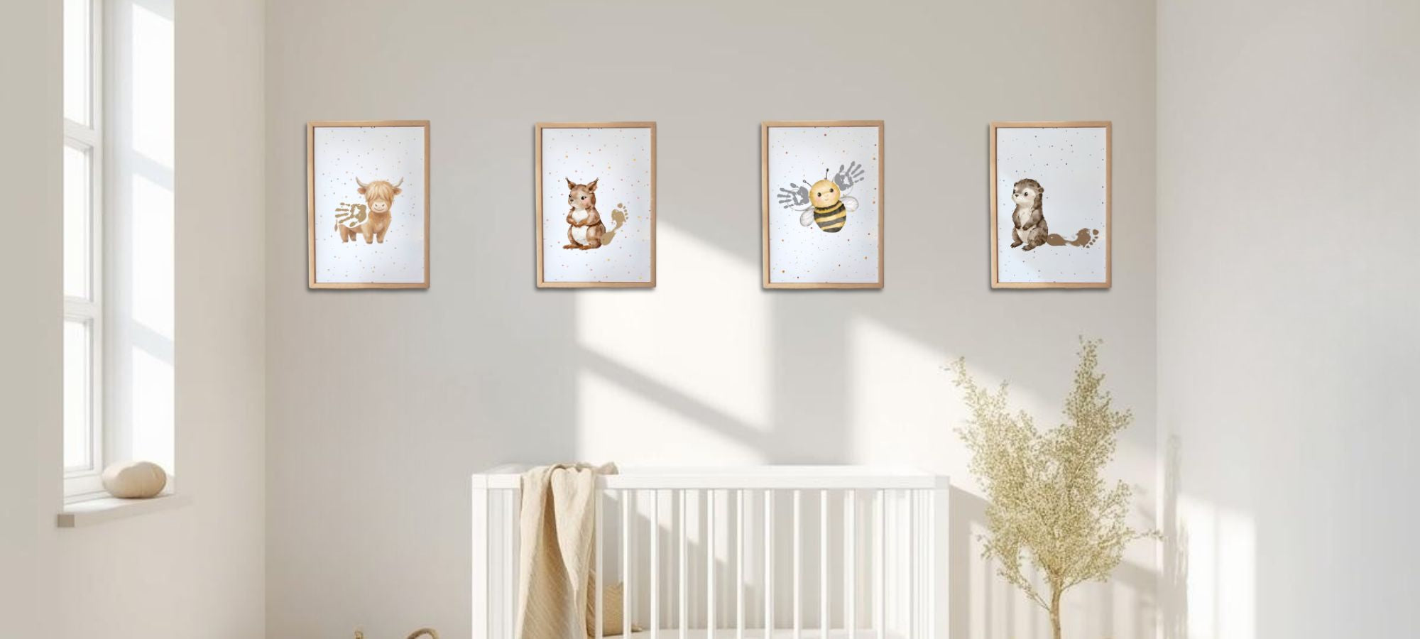 Nursery room with white crib and framed animal prints on the wall. Woodland and Meadow theme, handprint and footprint wall art decor