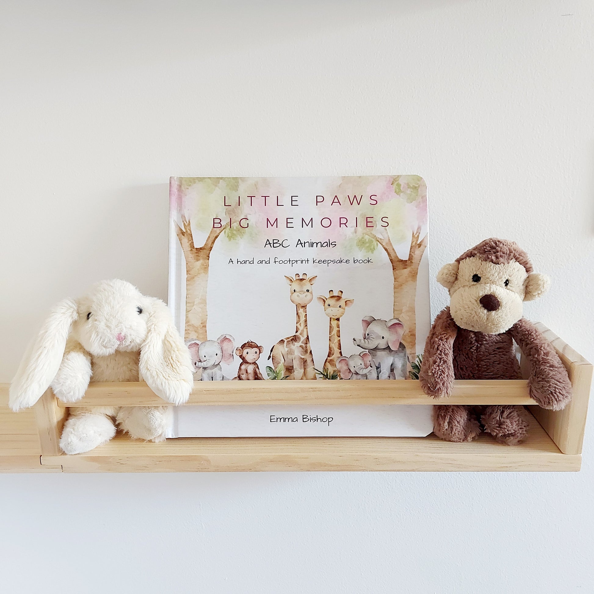 Little Paws Big Memories ABC Animals baby handprint and footprint keepsake memory book kit. Book on nursery shelf with soft toy monkey and rabbit. Newborn baby gift idea, baby shower gift idea. Christening present. 