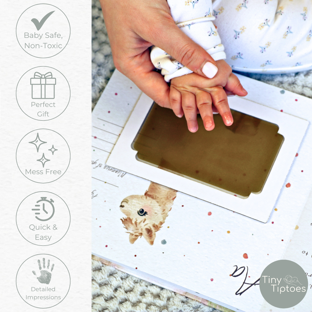 Taking a baby handprint with mess free ink pad, featuring 'Tiny Tiptoes' brand