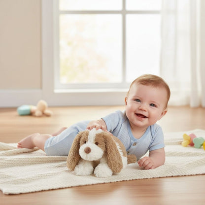 Baby lying on a rug holding a plush toy dog in a bright room
