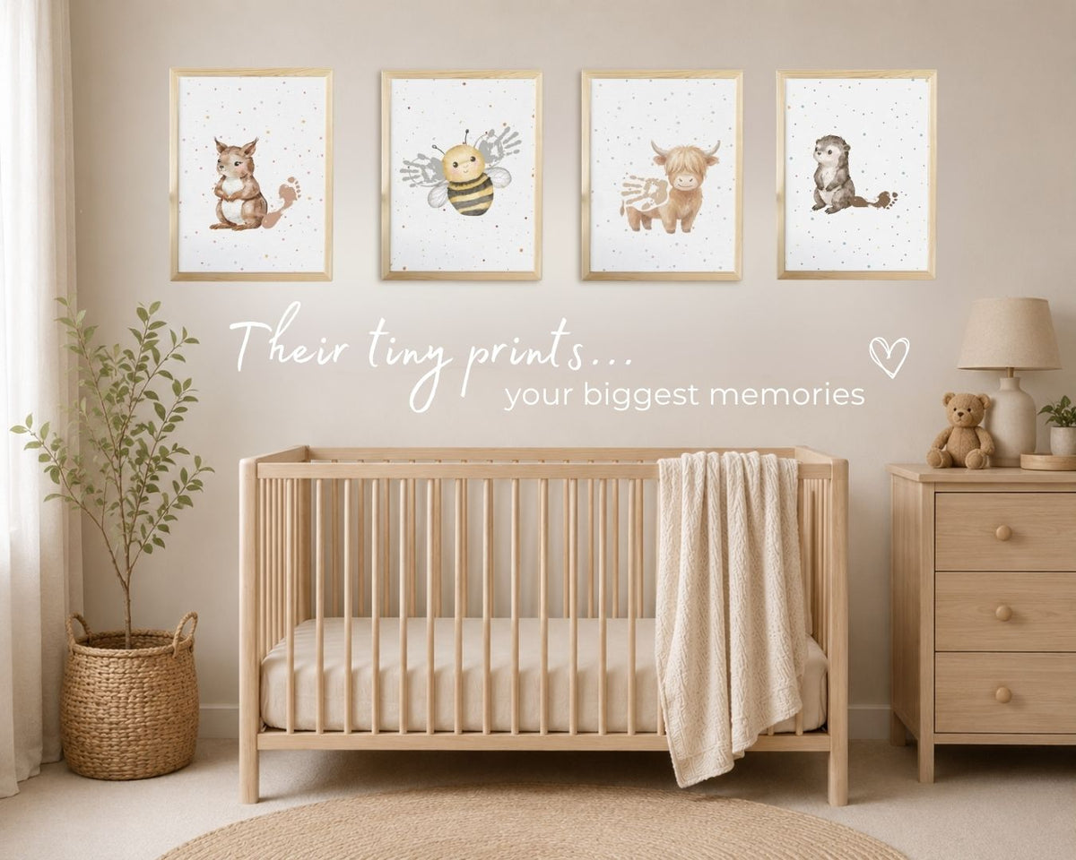 A styled nursery scene with four framed animal prints hanging above a light wood crib. The prints show a squirrel, a bee, a cow, and an otter on a speckled white background. 