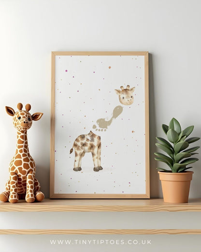 Framed children's illustration of a giraffe with child's footprint on a shelf with a toy giraffe and plant.