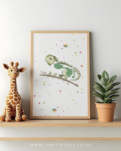 Framed children's illustration of a green iguana with a footprint body on a branch with a stuffed giraffe and potted plant on a shelf.