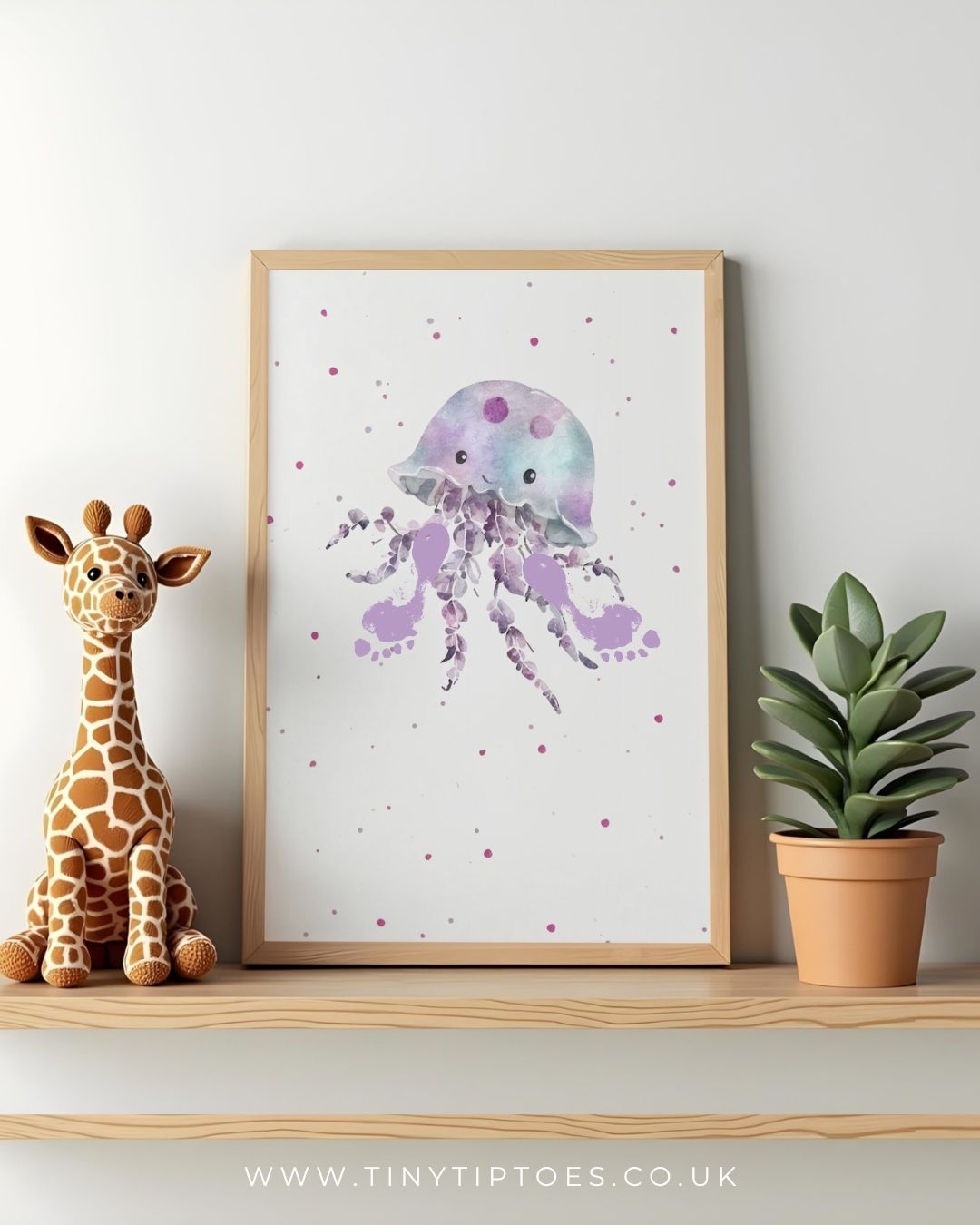 Framed jellyfish footprint artwork on a shelf with a toy giraffe and plant