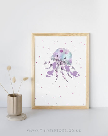 Framed artwork of a purple jellyfish with footprint tentacles on a white background with polka dots, next to a vase with dried plants.