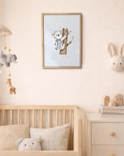 Nursery room with a framed picture of a koala on a tree, crib with stuffed animals, and toys. baby's handprint makes the koala's body