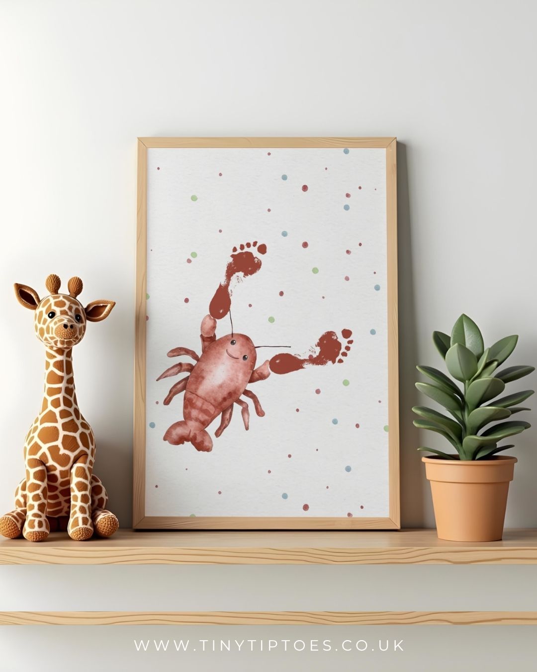 Framed illustration of a lobster with footprint claws on a shelf with a toy giraffe and plant.