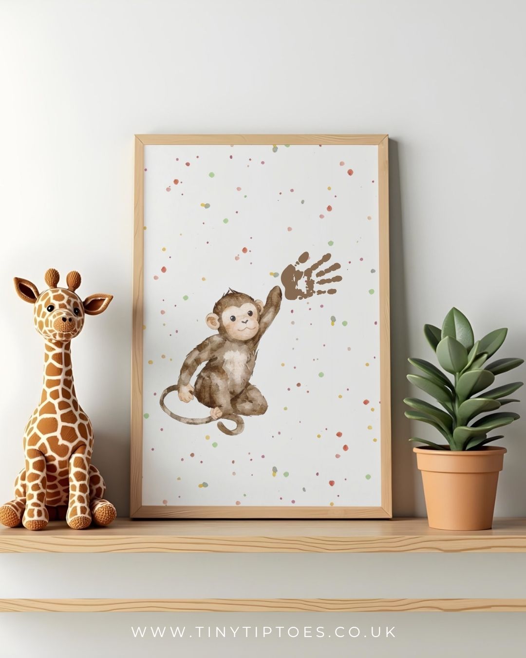 Framed children's illustration of a monkey and giraffe on a shelf with a plant and toy.