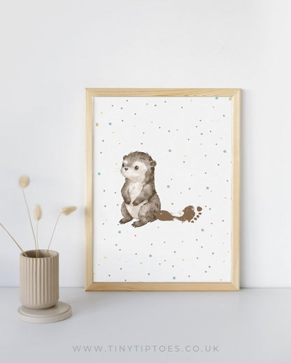 Framed artwork of a otter with a footprint tail on a white background with a wooden frame.
