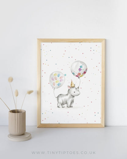 Framed artwork of a rhino with colorful fingerprint balloons on a white background, displayed on a shelf.