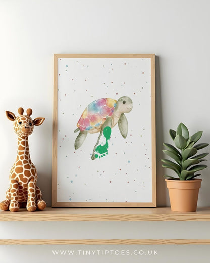 Framed artwork of a colorful turtle footprint on a shelf with a toy giraffe and plant.