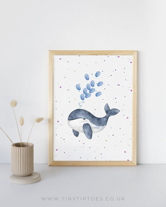 Framed artwork of a whale with fingerprint bubbles on a white background, displayed on a shelf.