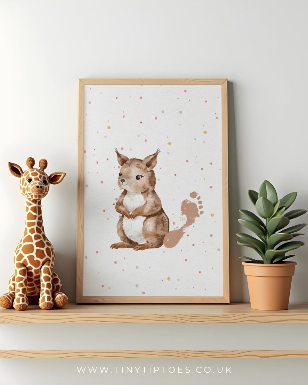 Framed illustration of a squirrel with a footprint tail on a shelf with a toy giraffe and plant.