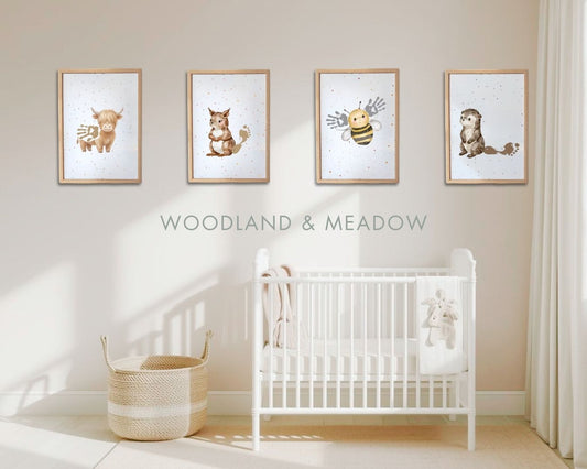 Nursery room with white crib and framed animal prints on the wall, featuring the text 'Woodland & Meadow'. highland cow, squirrel, bee and otter handprint and footprint framed artwork
