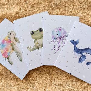 Greetings Cards Pack of 4 - Watercolour Turtle, Frog, Jellyfish, Whale. Blank inside. On plain linen cloth background.