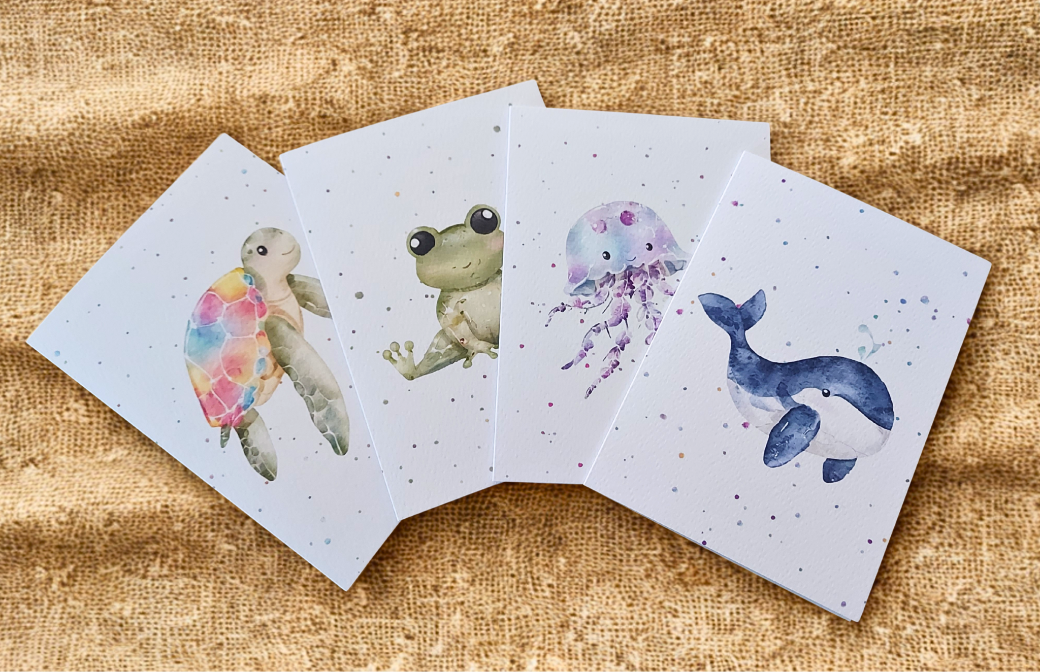 Greetings Cards Pack of 4 - Watercolour Turtle, Frog, Jellyfish, Whale. Blank inside. On plain linen cloth background.