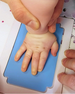 taking a baby's handprint with our mess free clean touch inkless ink pad