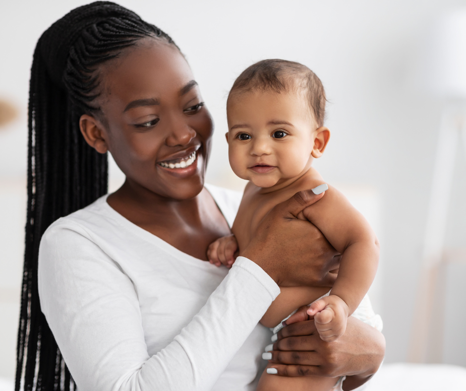 Mother holding smiling baby – joyful parent and baby moment representing meaningful baby memories and milestones