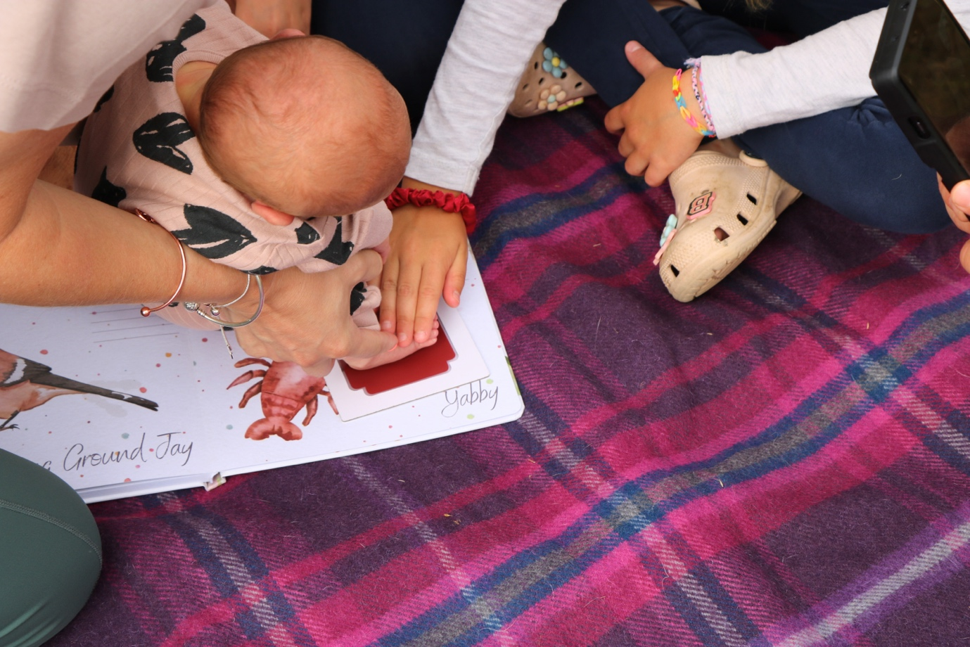 Baby handprint being captured on Tiny Tiptoes keepsake print – meaningful baby handprint memory creation